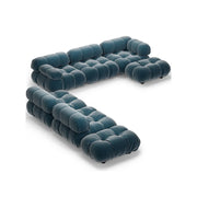 Blue tufted sofa on a white background